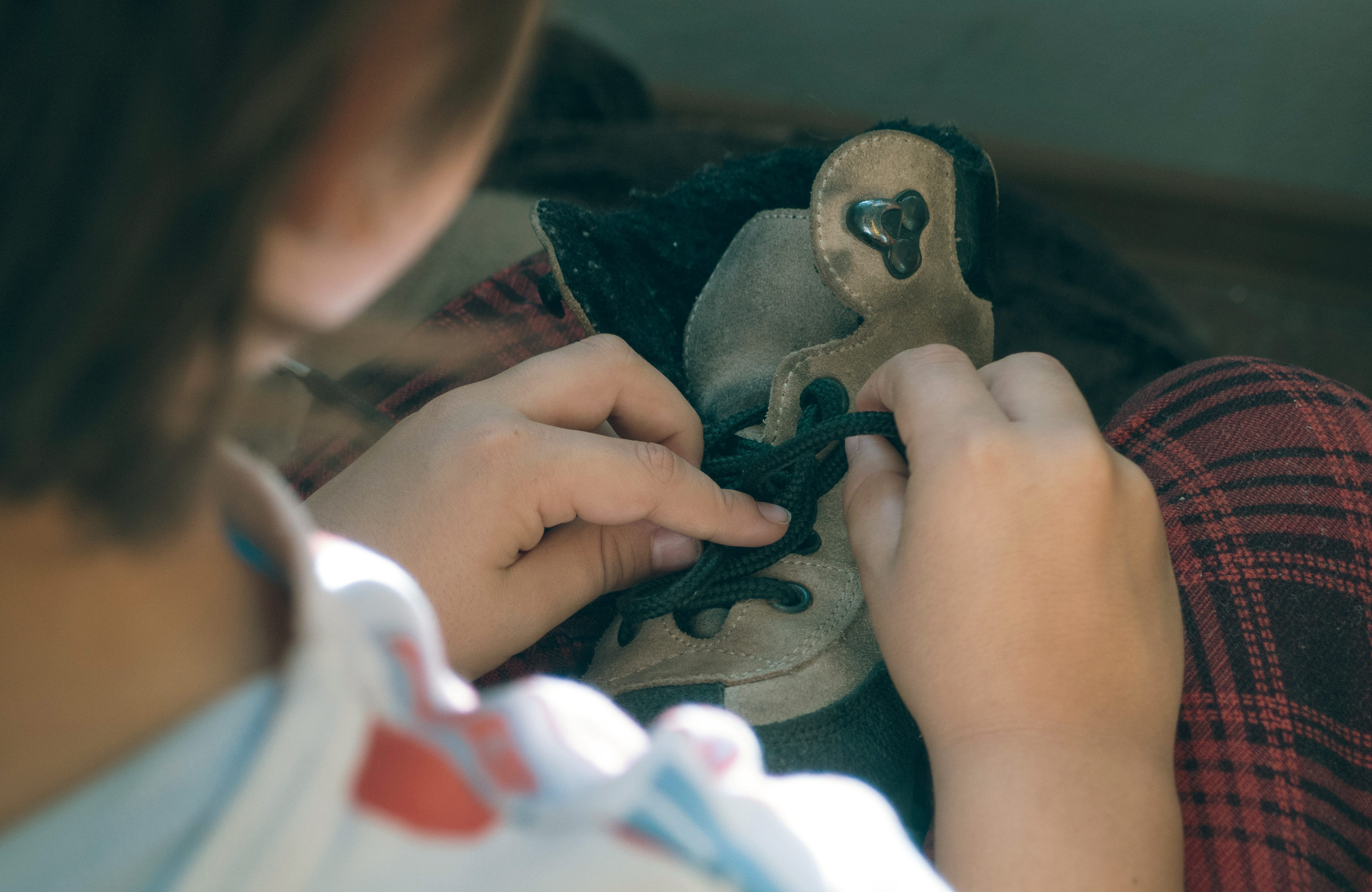 Boy trying to tie his shoes